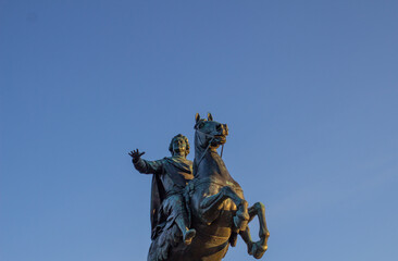 Fototapeta na wymiar Statue of Peter the Great on horseback against blue sky, Bronze Horseman