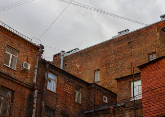 Fototapeta na wymiar Old brick industrial buildings against a cloudy sky