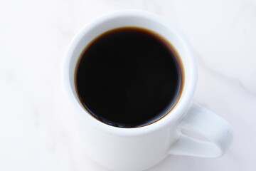 Fototapeta na wymiar 淹れたてのフレッシュなコーヒーが入ったコーヒーカップ