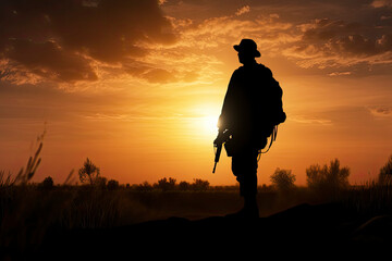 A black silhouette of an american soldier patrolling the sunset - obrazy, fototapety, plakaty