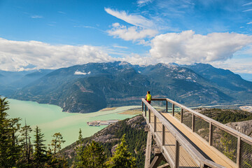 Squamish, British Columbia nature with hiking woman hiker in looking at view of amazing landscape...