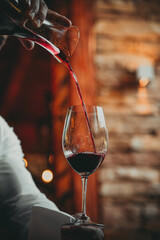 red wine pouring into glass