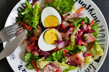 Green salad from green leaves mix and vegetables. Top view