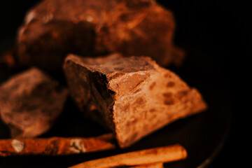 Chocolate. Chunks of dark chocolate rotate on dark background, rotate. Gourmet dessert ingredient. Confectionery, confection concept.