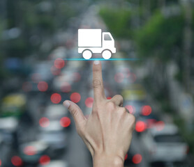 Hand pressing delivery truck flat icon over blur of rush hour road in city, Business transportation service concept