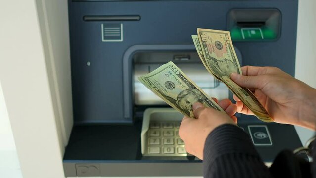 Business woman counting us dollars near ATM machine  Generative AI