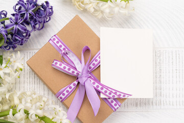Obraz na płótnie Canvas Beautiful gift box with hyacinths and blank card