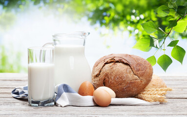 Homemade bread and milk on wooden table