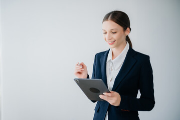 Smiling caucasian young businesswoman bank employee worker manager boss ceo looking at camera, using tablet, laptop and notepad online isolated background..