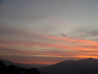 A fascinating view of dusk after sunset as clouds turns into pin-yellowish-golden color in the sky look mesmerizing at Gangtok in Sikkim. ...