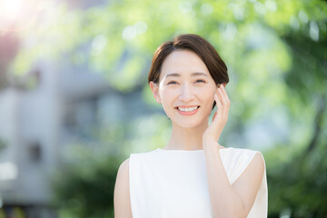 Beauty image of a beautiful person in fresh greenery Front smiling face Copy space available on the...
