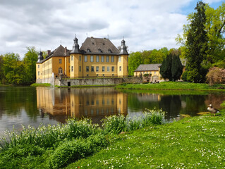 Romantic yellow water castle Schloss Dyck in Juechen in Germany