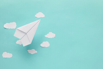 white paper plane and cloud on blue background 