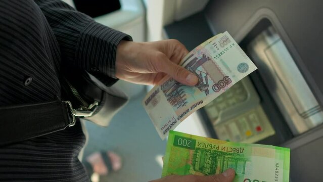 Business woman counting russian ruble near ATM machine  Generative AI