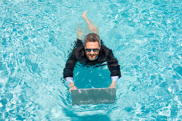 Summer business. Freelancer in swimming pool. Business man in wet suit in swimming pool. Crazy...