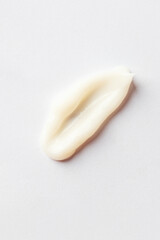 Top view of white cream smear, cosmetic swatch and sample.