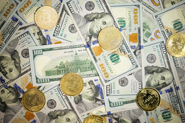 Online business concept. Golden Bitcoin lies on the banknotes.