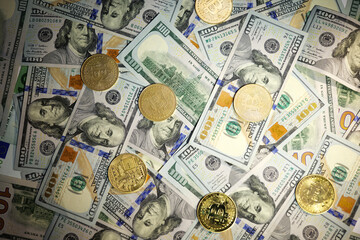 Online business concept. Golden Bitcoin lies on the banknotes.