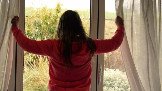 Woman opening curtains in room to summer day  Generative AI