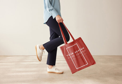 Mockup of customizable tote bag being modelled by woman, low section