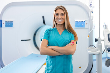 Beautiful happy female doctor physician radiologist standing in CT CAT Scan room at hospital.