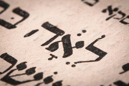 Closeup of hebrew word in Torah page. English translation is name Leah. Unloved wife of the Biblical patriarch Jacob. Selective focus.