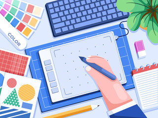 A vector illustration shows a hand drawing on a digital drawing tablet, surrounded by various designer/illustrator tools and equipment such as color palette, sketchbook, pencil. Creative workspace.