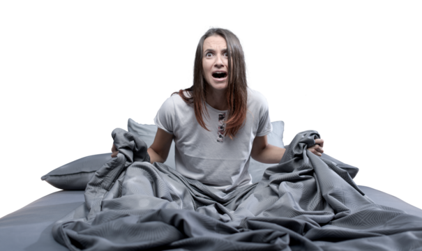 Shocked woman waking up from a nightmare