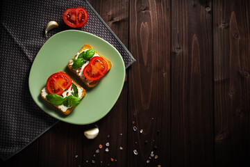 Variation of healthy toasts with cream cheese on a plate. Delicious sandwiches. Food composition, tasty Italian meal. Top view, copy space.