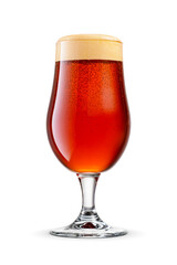 Tulip glass of fresh dark brown beer with cap of foam isolated.