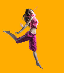 beauty girl dance on orange background. person jumping, flying in the air