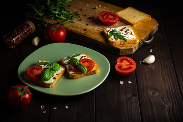 Cooking sandwiches with vegetables for breakfast together at wooden table.
