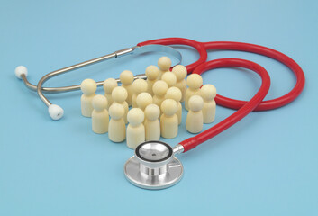 Large group of people figures surrounded by stethoscope. Health insurance concept.