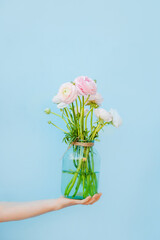 Flowers to gift. Beautiful ranunculus in female hands. Spring time and inspiration