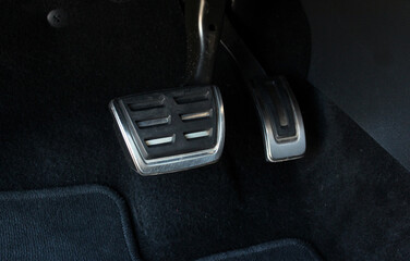 Close up the foot pressing foot pedal of a car to drive. Accelerator and brake pedal in a car....