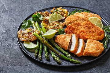 fried chicken breasts with asparagus and potatoes