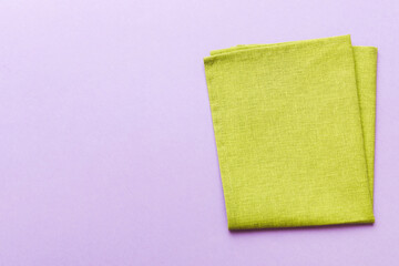 top view with green kitchen napkin isolated on table background. Folded cloth for mockup with copy...