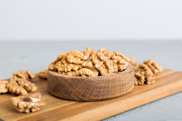 Fresh healthy walnuts in bowl on colored table background. Top view Healthy eating bertholletia concept. Super foods