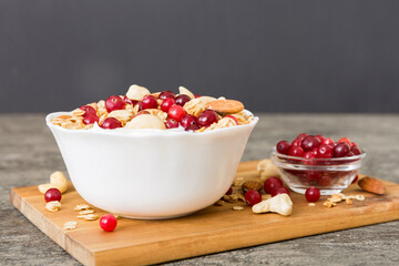 Healthy breakfast food with granola, yogurt, fruits and nuts. Dessert parfait with dried fruits for breakfast