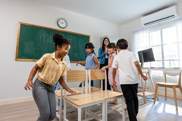 Group of student learn with teacher in classroom at elementary school. 