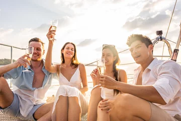 Fotobehang Group of diverse friends drink champagne while having a party in yacht.  © Kawee