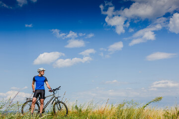 Fototapeta na wymiar Mountain Bike cyclist on a sunny day. Healthy Lifestyle and Travel Concept