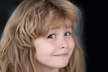 Portrait of funny blonde kid. Close-up face of cute child. Portrait of kid boy at home. Close up face of happy child alone.