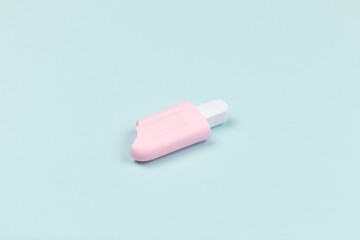 closeup of a pink popsicle on cyan surface icecream