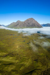 Aerial view of low cloud and fog in a valley just after dawn (Glencoe, Scottish Highlands)
