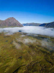 Aerial view of low cloud and fog in a valley just after dawn (Glencoe, Scottish Highlands)