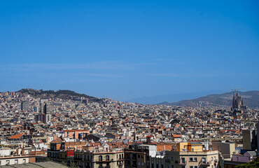 Fototapeta na wymiar The wide panorama of the roofs of Barcelona with Sagrada Familia. 