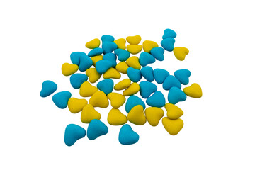 A bunch of yellow and blue heart-shaped candies (close-up) on a transparent background. State symbols of Ukraine