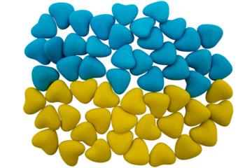 Yellow-blue heart-shaped candies are laid out in the form of the national flag of Ukraine on a transparent background