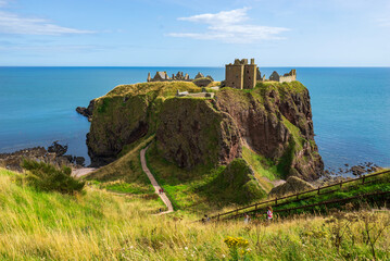 Dunnnottar Castle in the rocky headland above the sea. Medieval fortress in Scotland coast. Great Britain, United Kingdom.